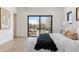 Bright main bedroom with a private balcony offering neighborhood views and a comfortable king-size bed at 2900 S Adams St, Denver, CO 80210