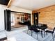 Inviting covered patio features a dining area, wood accent wall, and access to the gourmet kitchen at 2900 S Adams St, Denver, CO 80210