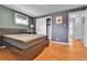 Bedroom features hardwood floors, blue walls, two windows, and closet with white sliding doors at 4680 Independence St, Wheat Ridge, CO 80033