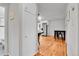 Hallway leading to kitchen featuring hardwood floors and access to updated bathroom at 4680 Independence St, Wheat Ridge, CO 80033