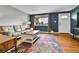 Living room showcases a comfortable sofa and a stylish coffee table, all on hardwood floors and with natural light at 4680 Independence St, Wheat Ridge, CO 80033
