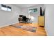 Bright office space with hardwood floors, two windows, neutral walls, and contemporary furnishings at 4680 Independence St, Wheat Ridge, CO 80033