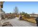 Back deck with a table and chairs, outdoor seating, and wood and stone railings with panoramic neighborhood views at 3174 Soaring Eagle Ln, Castle Rock, CO 80109
