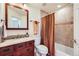 Bathroom with a wooden vanity and mirror, a neutral tiled bath and shower combination, and new fixtures at 3174 Soaring Eagle Ln, Castle Rock, CO 80109