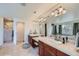 A well-lit bathroom featuring double sinks, a large mirror, and a separate shower and soaking tub at 3174 Soaring Eagle Ln, Castle Rock, CO 80109