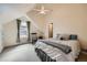 Lofted bedroom with an interesting window and neutral decor at 3174 Soaring Eagle Ln, Castle Rock, CO 80109