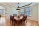 Elegant dining room with hardwood floors, tray ceiling, and large windows at 3174 Soaring Eagle Ln, Castle Rock, CO 80109