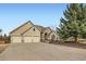 Charming stucco home featuring a three-car garage and a meticulously landscaped front yard at 3174 Soaring Eagle Ln, Castle Rock, CO 80109