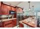 Elegant kitchen features custom wood cabinetry, granite countertops, and a built-in wine cooler for entertaining at 3174 Soaring Eagle Ln, Castle Rock, CO 80109