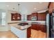 Modern kitchen with granite countertops, stainless steel appliances, and custom wood cabinetry at 3174 Soaring Eagle Ln, Castle Rock, CO 80109
