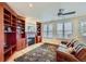 Cozy living room featuring a fireplace, custom built-ins, and large windows for natural light at 3174 Soaring Eagle Ln, Castle Rock, CO 80109