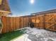 Fenced back yard with a combination of artificial turf and concrete, surrounded by a wood fence at 12993 W 20Th Ave, Golden, CO 80401