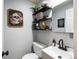 Cozy half bathroom with decorative shelving and unique skull artwork at 12993 W 20Th Ave, Golden, CO 80401
