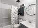 Nicely updated bathroom features a vanity with a round mirror and a shower/tub combination at 12993 W 20Th Ave, Golden, CO 80401