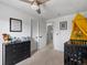 Neutral bedroom with a dark dresser and black crib under a yellow canopy at 12993 W 20Th Ave, Golden, CO 80401