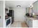 Modern kitchen with black appliances, gray cabinets, tile floors, and natural light at 12993 W 20Th Ave, Golden, CO 80401