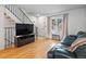 Bright living room featuring hardwood floors, modern furnishings, and a staircase leading to the upper level at 12993 W 20Th Ave, Golden, CO 80401