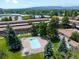 Aerial view of the fenced community pool surrounded by mature trees and green space at 12993 W 20Th Ave, Golden, CO 80401