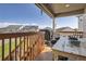 Cozy covered back deck with wood table, grill, and neighborhood views, perfect for outdoor entertaining and relaxation at 21038 E Quincy Pl, Aurora, CO 80015