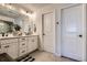 Modern bathroom featuring a double vanity with sleek fixtures and ample storage space at 21038 E Quincy Pl, Aurora, CO 80015