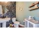 Charming powder room featuring unique wallpaper, stylish lighting, and rustic accents at 21038 E Quincy Pl, Aurora, CO 80015