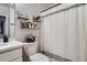 Bright bathroom featuring a shower with a curtain, floating shelves, and modern fixtures at 21038 E Quincy Pl, Aurora, CO 80015