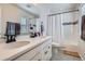Bright bathroom with double sinks, modern fixtures, and a shower-tub combination with stylish curtain at 21038 E Quincy Pl, Aurora, CO 80015