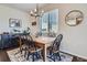 Charming dining area with natural lighting, rustic wood furniture, and stylish decor at 21038 E Quincy Pl, Aurora, CO 80015