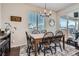 Bright dining area featuring a wooden table, black chairs, and natural light from a window at 21038 E Quincy Pl, Aurora, CO 80015