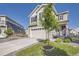 Charming two-story home featuring a manicured lawn, complemented by a modern two-car garage and beautiful curb appeal at 21038 E Quincy Pl, Aurora, CO 80015