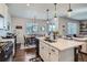 Bright kitchen with modern island, stainless appliances, and open layout to dining area at 21038 E Quincy Pl, Aurora, CO 80015