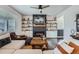 Cozy living room with a fireplace, built-in shelves, and a comfortable sectional sofa at 21038 E Quincy Pl, Aurora, CO 80015