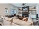 Stylish living room with fireplace, built-in shelving, large sectional sofa, and lots of natural light through the window at 21038 E Quincy Pl, Aurora, CO 80015