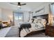 Spacious main bedroom featuring a ceiling fan, modern decor, and a large window for natural light at 21038 E Quincy Pl, Aurora, CO 80015
