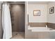 Elegant bathroom showcasing a shower and soaking tub with tile surround and tasteful decorations at 2001 Lincoln St # 920, Denver, CO 80202