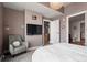 Cozy bedroom with a comfortable chair, television, and access to ensuite bathroom and kitchen at 2001 Lincoln St # 920, Denver, CO 80202