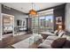 Contemporary living room boasts hardwood floors, city views, and an open doorway to the main bedroom at 2001 Lincoln St # 920, Denver, CO 80202