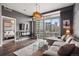 Open living room with gray walls, dark wood floor, large window, and city view at 2001 Lincoln St # 920, Denver, CO 80202