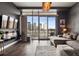 Sleek living room with a flatscreen TV, balcony access, and modern furnishings, perfect for city dwellers at 2001 Lincoln St # 920, Denver, CO 80202