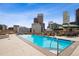 Rooftop pool with city views in this luxury building with lounge seating and shade at 2001 Lincoln St # 920, Denver, CO 80202