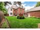 Spacious backyard with lush lawn, brick exterior home, outdoor seating, and manicured landscaping for relaxation at 1332 S Lafayette St, Denver, CO 80210