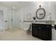 Bright bathroom featuring glass shower, decorative mirror, and modern vanity at 1332 S Lafayette St, Denver, CO 80210