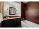 Bathroom with vanity, shower-tub combo with unique brown tile, and modern fixtures at 1332 S Lafayette St, Denver, CO 80210