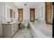 Stylish bathroom with a soaking tub, marble finishes, and wood trim at 1332 S Lafayette St, Denver, CO 80210