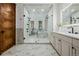 Luxurious bathroom with marble floors, a glass-enclosed shower, and modern fixtures at 1332 S Lafayette St, Denver, CO 80210