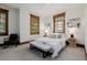 Cozy bedroom with neutral decor, wood window trim, and bench at the foot of the bed at 1332 S Lafayette St, Denver, CO 80210