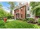 Attractive brick residence featuring manicured lawn, garden beds, and decorative planters at 1332 S Lafayette St, Denver, CO 80210