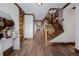 Spacious hallway showcasing hardwood floors, wooden trim, staircase, and natural light at 1332 S Lafayette St, Denver, CO 80210