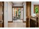 Hallway featuring hardwood floors, wooden trim, and view into dining room at 1332 S Lafayette St, Denver, CO 80210