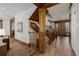 Hallway featuring hardwood floors, custom wood trim, staircase, and decorative artwork at 1332 S Lafayette St, Denver, CO 80210